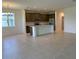Open concept living room and kitchen featuring stainless steel appliances and tiled floors at 2043 Town Pasture Dr, Eustis, FL 32726