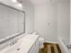 Bright bathroom featuring a large mirror and a vanity with modern hardware at 215 Rydalmont Rd, Winter Haven, FL 33884