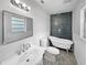 Bright bathroom with claw foot tub, patterned tile, subway tile shower, and updated fixtures at 215 Rydalmont Rd, Winter Haven, FL 33884