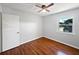 Bedroom featuring wood flooring, a window overlooking the front yard, and a closet at 215 Rydalmont Rd, Winter Haven, FL 33884