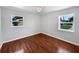 Hardwood flooring in this minimalistic bedroom with two windows offering lots of natural light at 215 Rydalmont Rd, Winter Haven, FL 33884