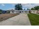 Charming single-story home with a well-manicured lawn, a new roof, and a long driveway at 215 Rydalmont Rd, Winter Haven, FL 33884