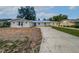 Charming single-story home with a well-manicured lawn, a new roof, and a long driveway at 215 Rydalmont Rd, Winter Haven, FL 33884