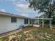 Back exterior view showcasing the sunroom addition at 215 Rydalmont Rd, Winter Haven, FL 33884