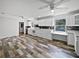 Modern kitchen featuring white cabinets, granite countertops, and wood-look flooring at 215 Rydalmont Rd, Winter Haven, FL 33884