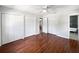Spacious main bedroom featuring three closets, wood flooring, and a ceiling fan at 215 Rydalmont Rd, Winter Haven, FL 33884