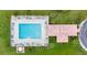 Aerial view of community pool, cabana, and surrounding green space, highlighting amenities and overall layout at 219 Isle Of Sky Cir, Orlando, FL 32828