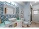 Contemporary bathroom featuring stylish sink, glass shower, blue-tile accent wall, and modern fixtures at 219 Isle Of Sky Cir, Orlando, FL 32828