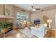 Cozy living room with a fireplace, large windows with golf course view, and comfortable seating at 219 Isle Of Sky Cir, Orlando, FL 32828