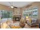 Bright living room with fireplace, comfortable furniture and golf course views at 219 Isle Of Sky Cir, Orlando, FL 32828