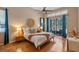 Spacious main bedroom with hardwood floors, ceiling fan, and sliding door access to the porch at 219 Isle Of Sky Cir, Orlando, FL 32828
