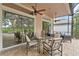 Large screened patio with dining and lounge furniture overlooking a manicured lawn and pool at 219 Isle Of Sky Cir, Orlando, FL 32828