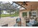 Relaxing screened patio with ceiling fans overlooks the pool and picturesque backyard at 219 Isle Of Sky Cir, Orlando, FL 32828