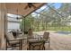 Spacious screened patio with comfortable seating, outdoor dining area, and a view of the lush backyard at 219 Isle Of Sky Cir, Orlando, FL 32828