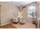 Cozy sitting area with comfortable seating, a ceiling fan, and natural light at 219 Isle Of Sky Cir, Orlando, FL 32828