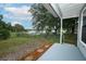 View from patio to a spacious backyard with a black fence and a serene lake beyond at 2304 Harding Cir, Deltona, FL 32738