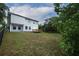 Expansive backyard featuring a deck and black metal fencing at 2304 Harding Cir, Deltona, FL 32738