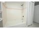 Bathroom with a white tiled shower/bathtub, shower head, soap dish, pink accent tile and white linen closet at 2304 Harding Cir, Deltona, FL 32738