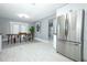 Bright dining area with modern furniture, rug, and adjacent to kitchen with stainless steel fridge at 2304 Harding Cir, Deltona, FL 32738