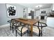 Dining area features modern decor, a wooden table set, rug, and view into adjacent kitchen at 2304 Harding Cir, Deltona, FL 32738