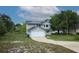 Two-story home with a two car garage, solar panels, and manicured lawn at 2304 Harding Cir, Deltona, FL 32738