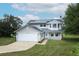 Charming two-story home with solar panels, a well-maintained lawn, and a two-car garage at 2304 Harding Cir, Deltona, FL 32738