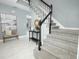Charming foyer featuring decorative accents and a staircase with black and white balusters at 2304 Harding Cir, Deltona, FL 32738