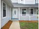 Inviting front porch with white railings and a decorative glass front door at 2304 Harding Cir, Deltona, FL 32738