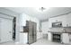 Modern kitchen with stainless steel appliances and bright white cabinetry at 2304 Harding Cir, Deltona, FL 32738