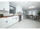 Open kitchen and dining area with white cabinets, stainless steel appliances, and wood countertops at 2304 Harding Cir, Deltona, FL 32738
