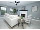 Cozy living room with a fireplace, large windows, and modern furnishings at 2304 Harding Cir, Deltona, FL 32738