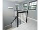 Top of staircase featuring black railing with white balusters and large windows at 2304 Harding Cir, Deltona, FL 32738