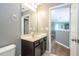 Neutral-painted bathroom featuring dark vanity, and vinyl flooring at 2515 Dharma Cir, Kissimmee, FL 34746