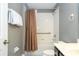 Bright bathroom featuring neutral paint, dark vanity, and shower-tub combination at 2515 Dharma Cir, Kissimmee, FL 34746