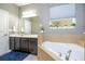 Bathroom features a large vanity, soaking tub, and decorative plants at 2515 Dharma Cir, Kissimmee, FL 34746