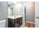 Bathroom features a dark vanity, neutral paint, and vinyl flooring at 2515 Dharma Cir, Kissimmee, FL 34746