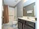 Bathroom showcasing dark vanity, neutral paint, and shower-tub combination at 2515 Dharma Cir, Kissimmee, FL 34746
