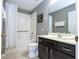 Bathroom features shower and tub combo, dark cabinets, and neutral paint at 2515 Dharma Cir, Kissimmee, FL 34746