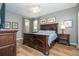 Bedroom with a large wood bed frame, matching bedside tables, dresser, and natural light at 2515 Dharma Cir, Kissimmee, FL 34746