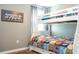 This is a cozy bedroom with hardwood floors and a bright white bunk bed with a colorful quilt and plenty of light at 2515 Dharma Cir, Kissimmee, FL 34746
