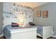Charming bedroom featuring hardwood floors, comic themed wallpaper, and natural light from the window at 2515 Dharma Cir, Kissimmee, FL 34746