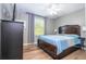 Bedroom with ceiling fan, TV, dark wood furnishings, and a bright window at 2515 Dharma Cir, Kissimmee, FL 34746