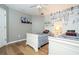 Comfortable bedroom showcasing twin beds, comic wallpaper, wood floors, and a ceiling fan at 2515 Dharma Cir, Kissimmee, FL 34746