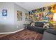 Upstairs bonus room area with comic book wallpaper and cozy furniture provides a space for relaxing at 2515 Dharma Cir, Kissimmee, FL 34746
