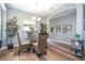 Dining area with wood floors, a glass table, and decorative accents at 2515 Dharma Cir, Kissimmee, FL 34746