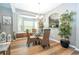 Cozy dining area with a glass table, four chairs, and decorative accents at 2515 Dharma Cir, Kissimmee, FL 34746