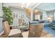 Dining area featuring a glass table, wicker chairs, and a view of the staircase at 2515 Dharma Cir, Kissimmee, FL 34746