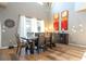 Dining area featuring a dark wood table, seating for eight, gray walls and sheer curtains at 2515 Dharma Cir, Kissimmee, FL 34746