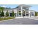 Community center entrance with covered walkway and well-maintained landscaping, providing a welcoming arrival at 2515 Dharma Cir, Kissimmee, FL 34746