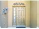 Close-up view of the front door, showcasing decorative details and sidelight, adding charm to the home's exterior at 2515 Dharma Cir, Kissimmee, FL 34746